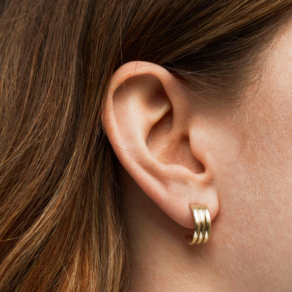 Trio 9kt gold hoop earrings on model by Skomer Studio